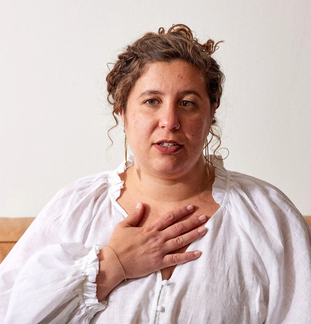 Laura Grossman, hand on chest, demonstrating a grounding practice
